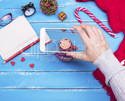 process of photographing a red cup of coffee