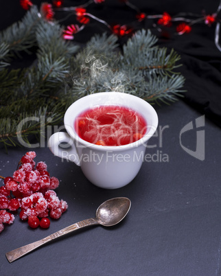tea from fresh red viburnum in a white ceramic cup
