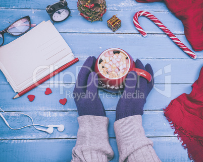 red cup of black coffee in female hands