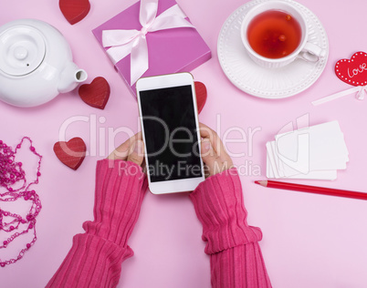 female hands  hold a smartphone with a black blank screen