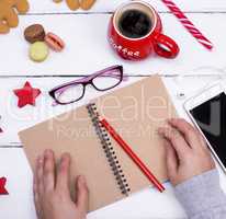 open empty notebook with a red pencil