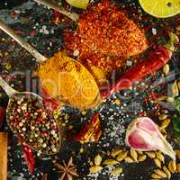 Variety of spices and herbs on kitchen table.