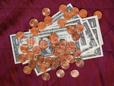 Dollar notes and coin, United States over red velvet background