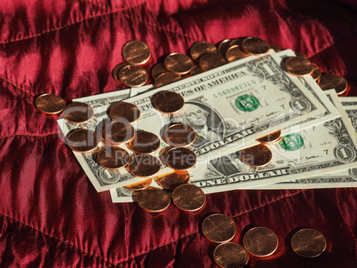 Dollar notes and coin, United States over red velvet background