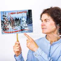 Woman holds sign with Christmas greetings