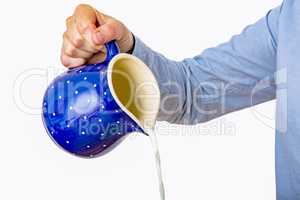 Woman pours from milk jug