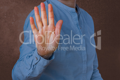Woman signals defensive attitude with hand
