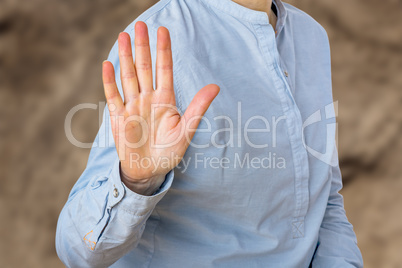 Woman signals defensive attitude with hand