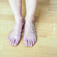Nude woman feet on the floor