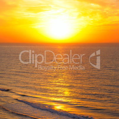 Bright golden sunrise over beach