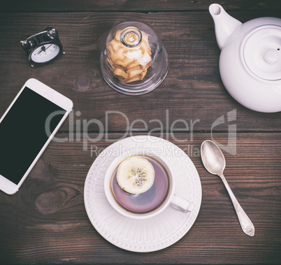 black tea with lemon in a round white ceramic cup