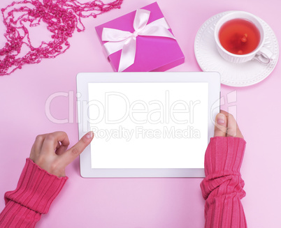 electronic tablet with an empty white screen in female hands