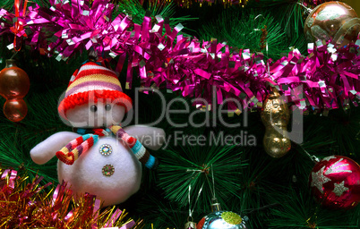 Artificial Christmas tree with toys and a snowman