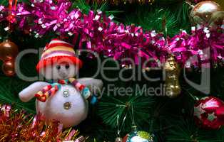Artificial Christmas tree with toys and a snowman