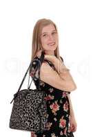 Young pretty woman standing with handbag
