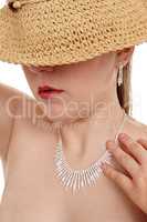 Woman covered eyes with straw hat