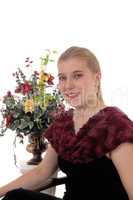 Woman sitting in black dress with flowers