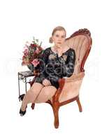 Beautiful woman sitting in old armchair