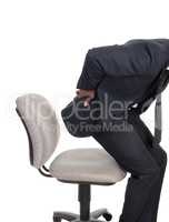 Man with back pain getting up from chair