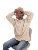 Happy young African man sitting with hat