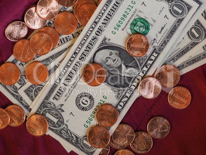 Dollar notes and coin, United States over red velvet background