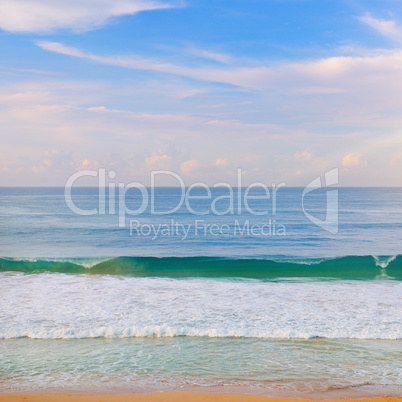 Tropical ocean, beach, high waves and blue sky.