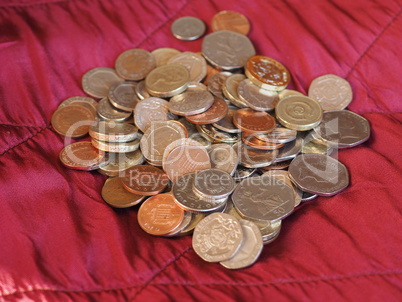 Pound coins, United Kingdom over red velvet background
