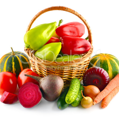 Set of vegetables in wicker basket isolated on white.