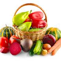 Set of vegetables in wicker basket isolated on white.