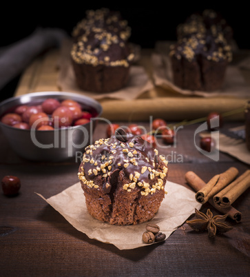 muffin sprinkled with nuts on a brown piece of kraft paper