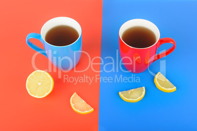 Red and blue cups with tea on a red and blue background. Flat la