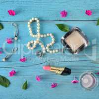 Set of decorative cosmetics on wooden table. Flat lay, top view.