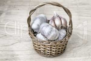 Garlic in a wicker basket on the table.