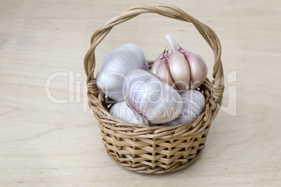 Garlic in a wicker basket on the table.