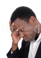 Depressed African man with hand on face