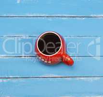 Black coffee in a red ceramic mug