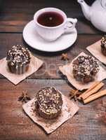 three chocolate muffins with nuts