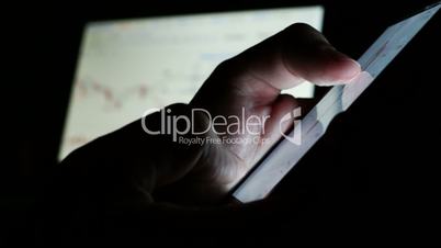 Man using phone for online trading on a stock market exchange.
