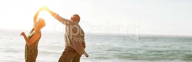 Senior couple dancing at beach