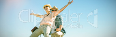 Happy casual couple going for a bike ride on the pier