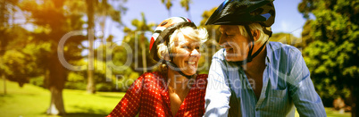 Happy couple riding a bicycle in park