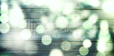 Composite image of light circles on green background