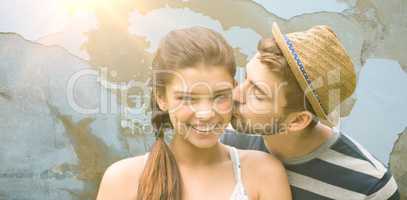 Composite image of man kissing woman