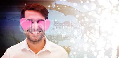 Composite image of handsome man with hearts over his eyes