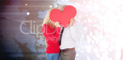 Composite image of handsome man getting a heart card form wife