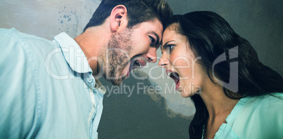 Composite image of couple shouting while standing face to face