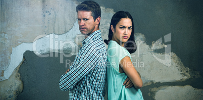 Composite image of portrait of displeased couple standing back to back