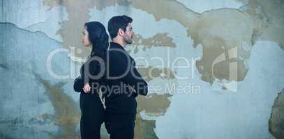 Composite image of profile view of sad couple standing back to back