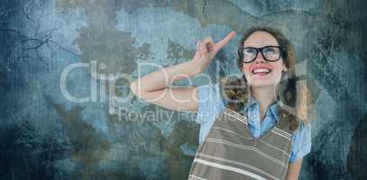 Composite image of geeky hipster woman pointing up
