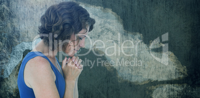 Composite image of upset woman with hands clasped